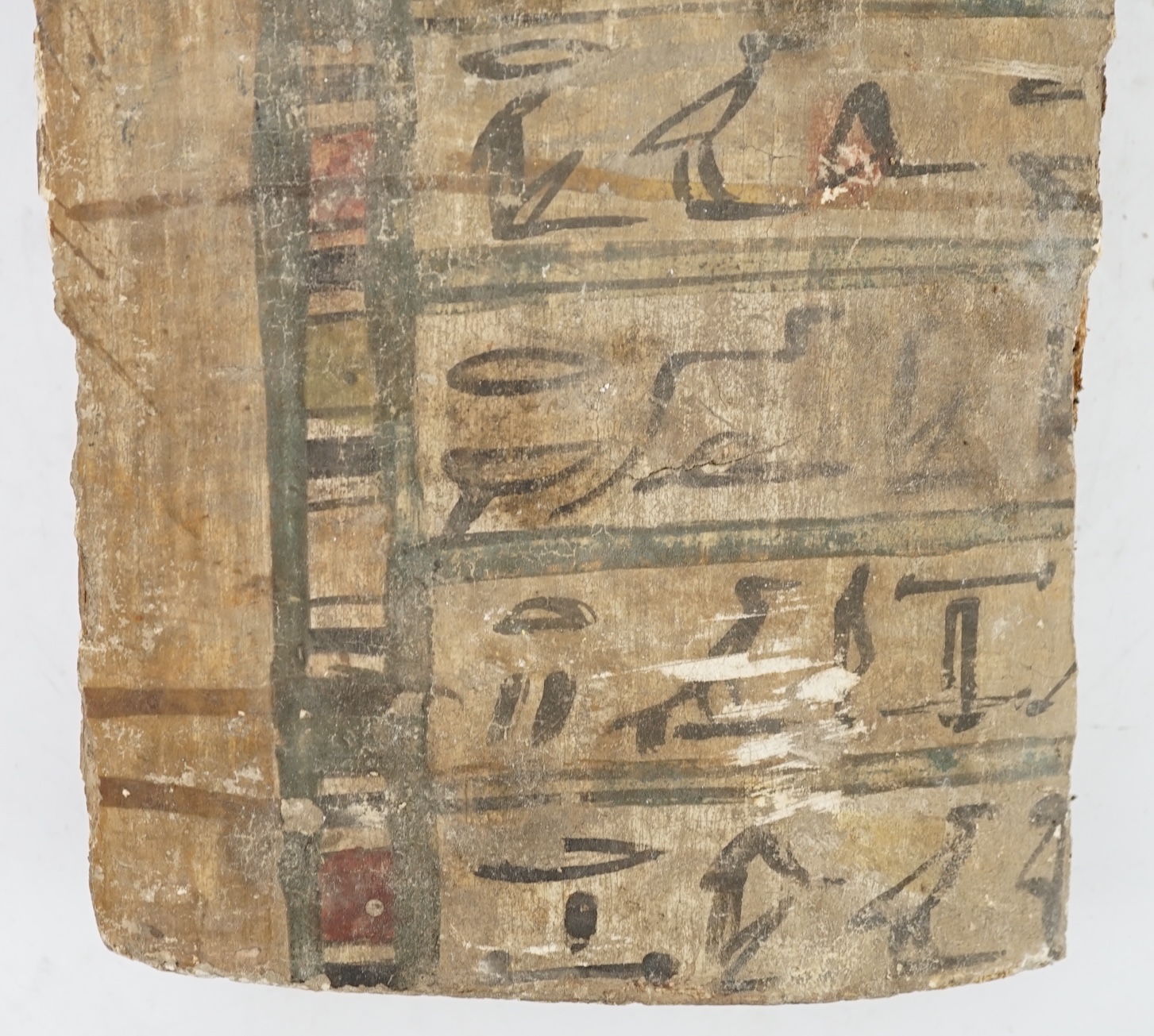 An Ancient Egyptian painted gesso, linen and wood fragment from a coffin or canopic chest, probably late Kingdom